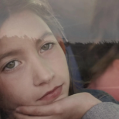 Girl looking out a bus window