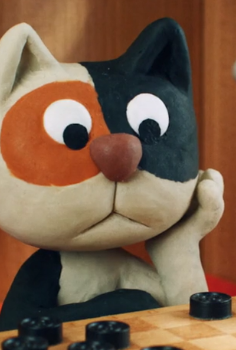 A Claymation ginger, black and white cat sits in front of a draughts bored, head in his paw.